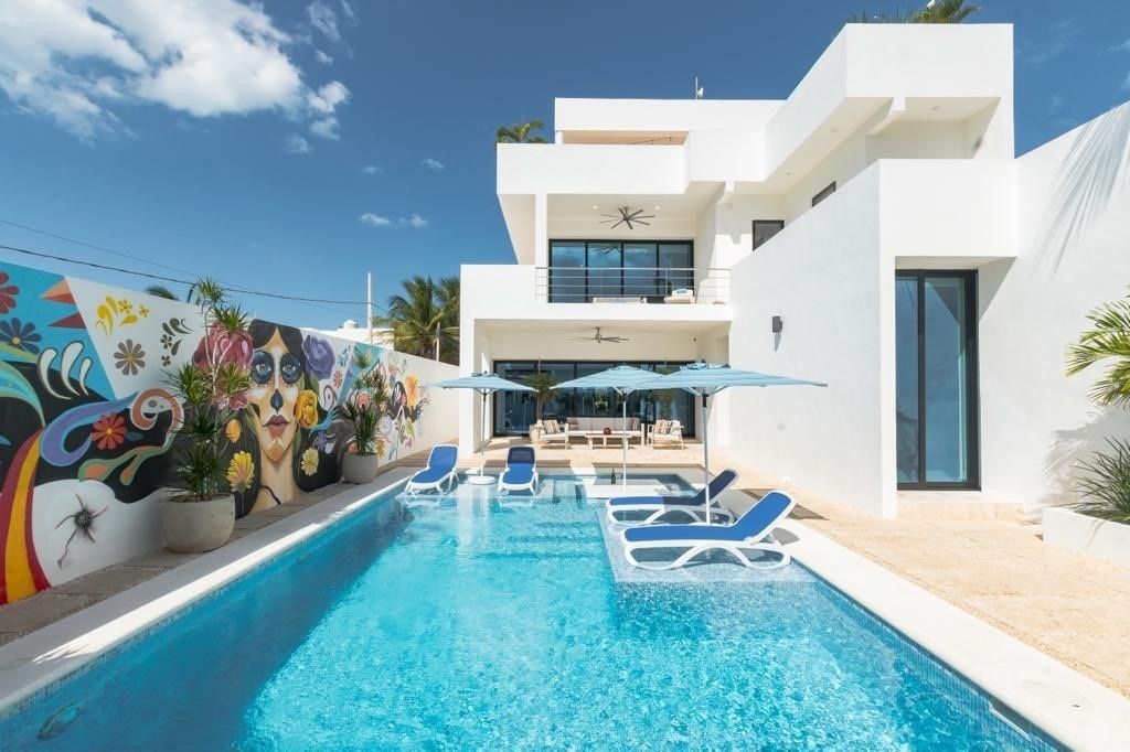 VIEW OF THE POOL AND MAIN HOUSE IN THE BACKGROUND