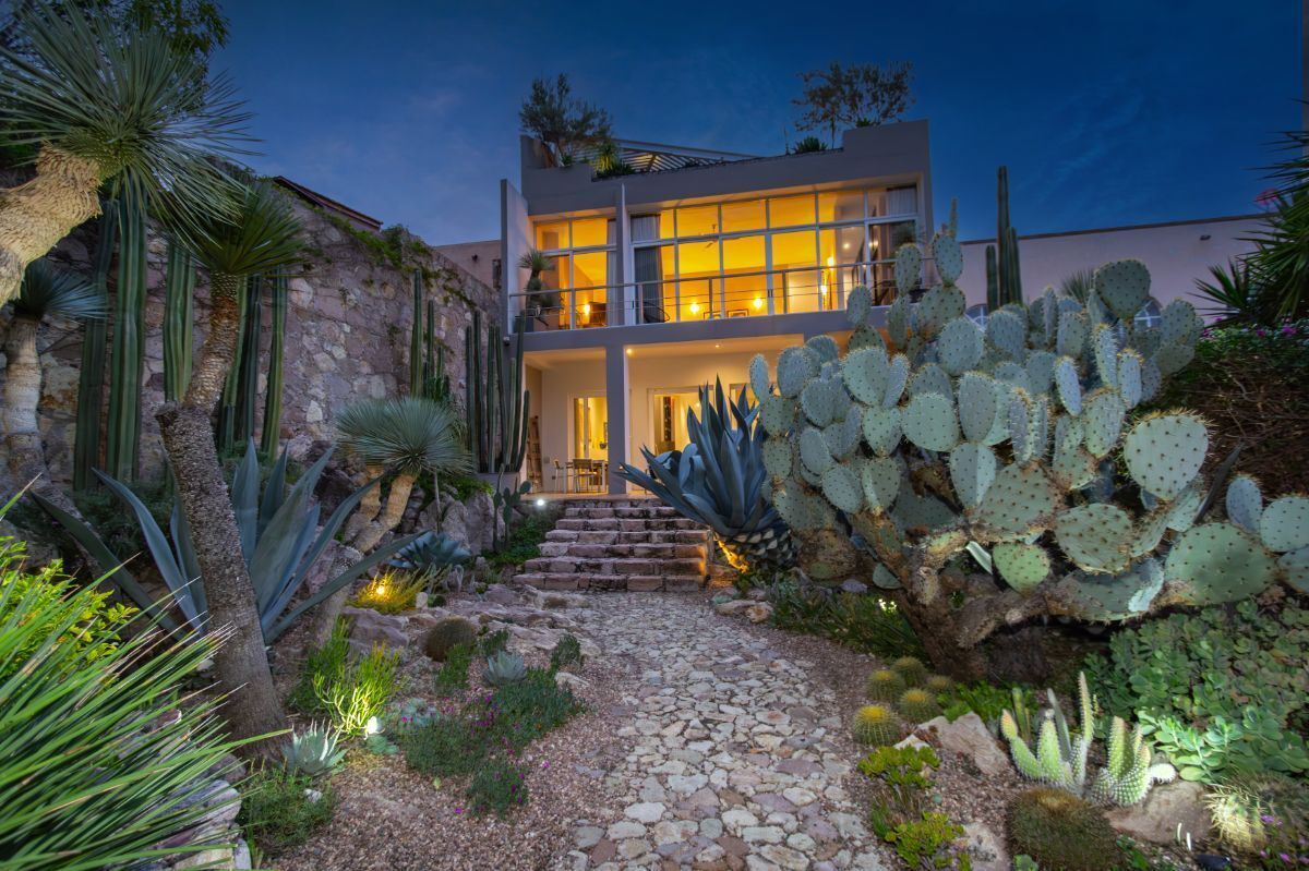 8 of 26: House view from the lush cacti garden
