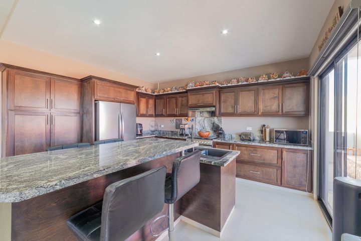 3 of 35: Huge kitchen with granite-topped, two-level island