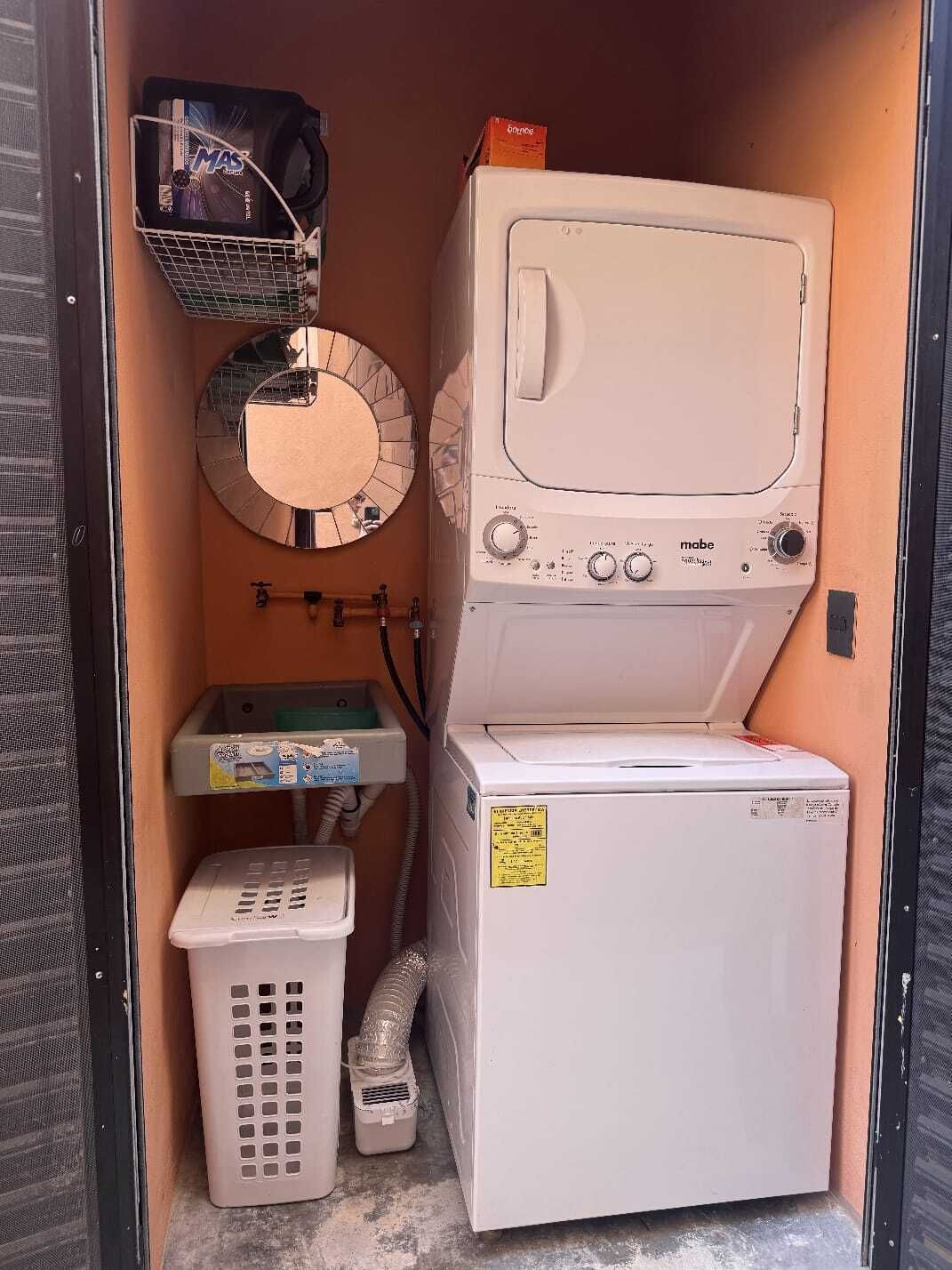 2 de 45: Laundry area with Mabe washer/dryer, utility sink.