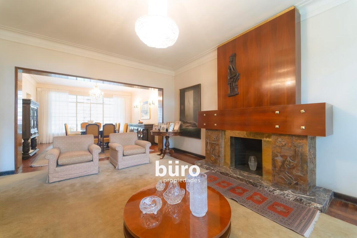 11 de 27: Gran sala con chimenea y vista al jardín frontal