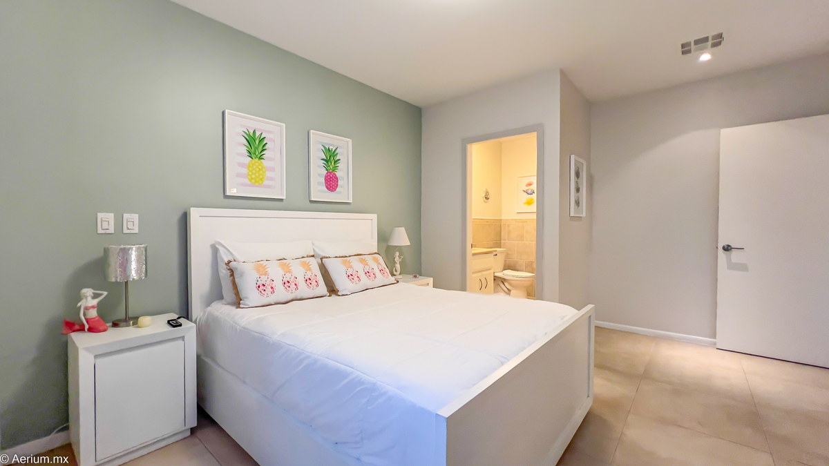 14 of 39: Secondary bedroom with full bathroom