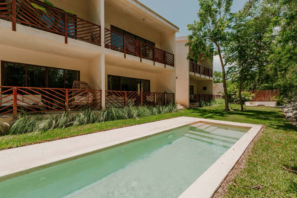 3 of 18: Unit and Poolside View of the Building
