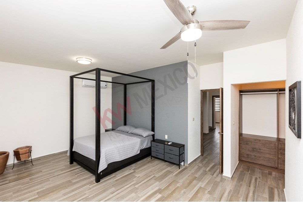 12 of 22: Primary bedroom with AC, fan, and private closet.