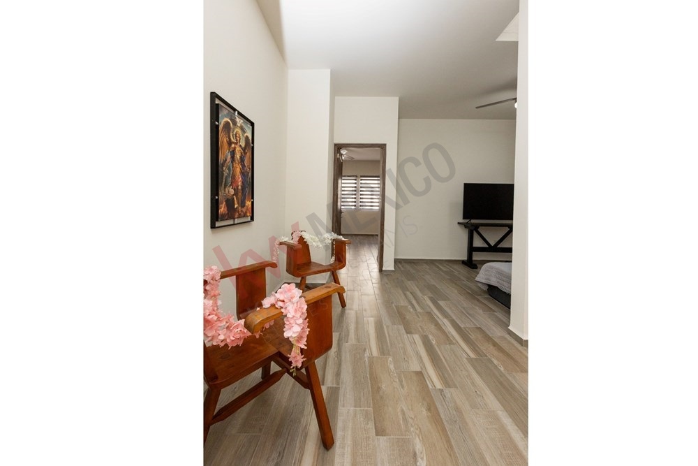 13 of 22: Bright upstairs TV area and hallway with wood tile.