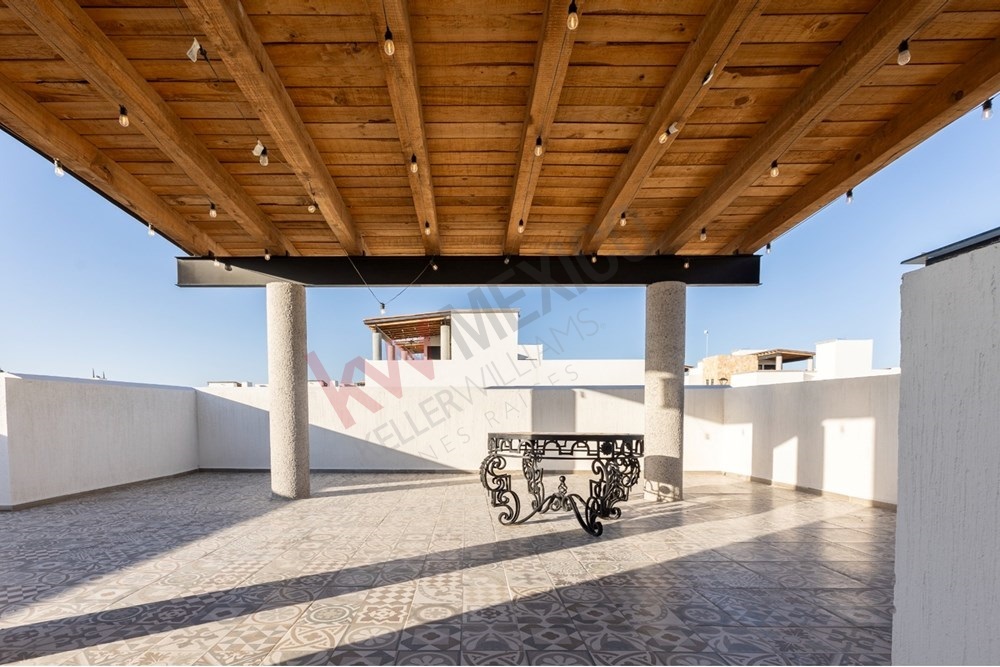 15 of 22: Covered rooftop terrace with beautiful tile and lighting.