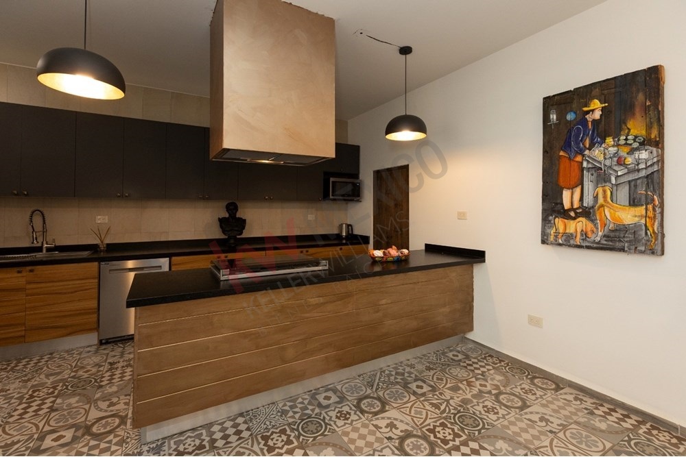 19 of 22: Modern kitchen, island cooktop, and beautiful patterned tile