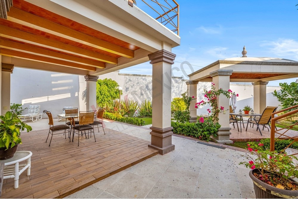 4 of 19: Colonial Covered Terrace, Outdoor Dining, Lush Garden