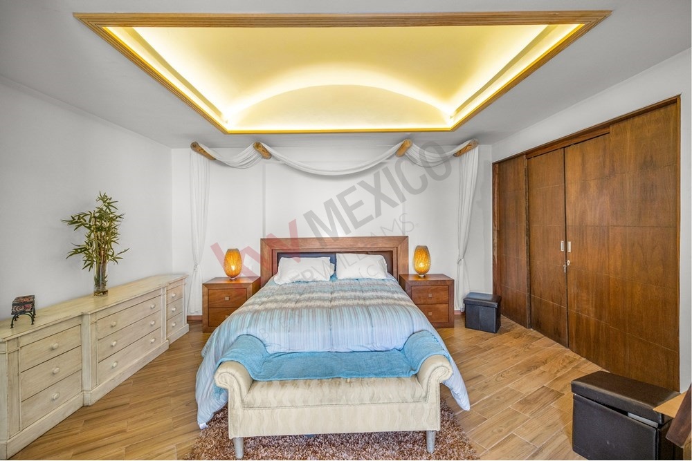 9 of 19: Bright Bedroom, Tufted Headboard, Floating Nightstand