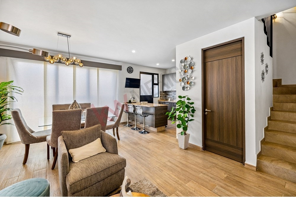 4 of 27: Glass Dining Table, Brick Accent Wall, Open Living