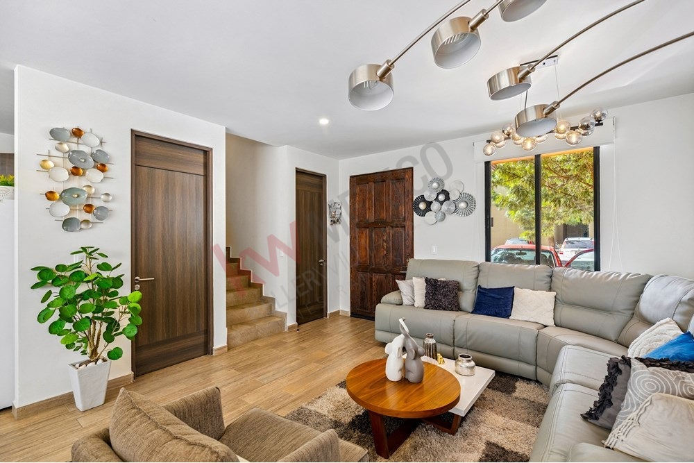 5 of 27: Bright Modern Living Room, Sectional Sofa, Wood Flooring.