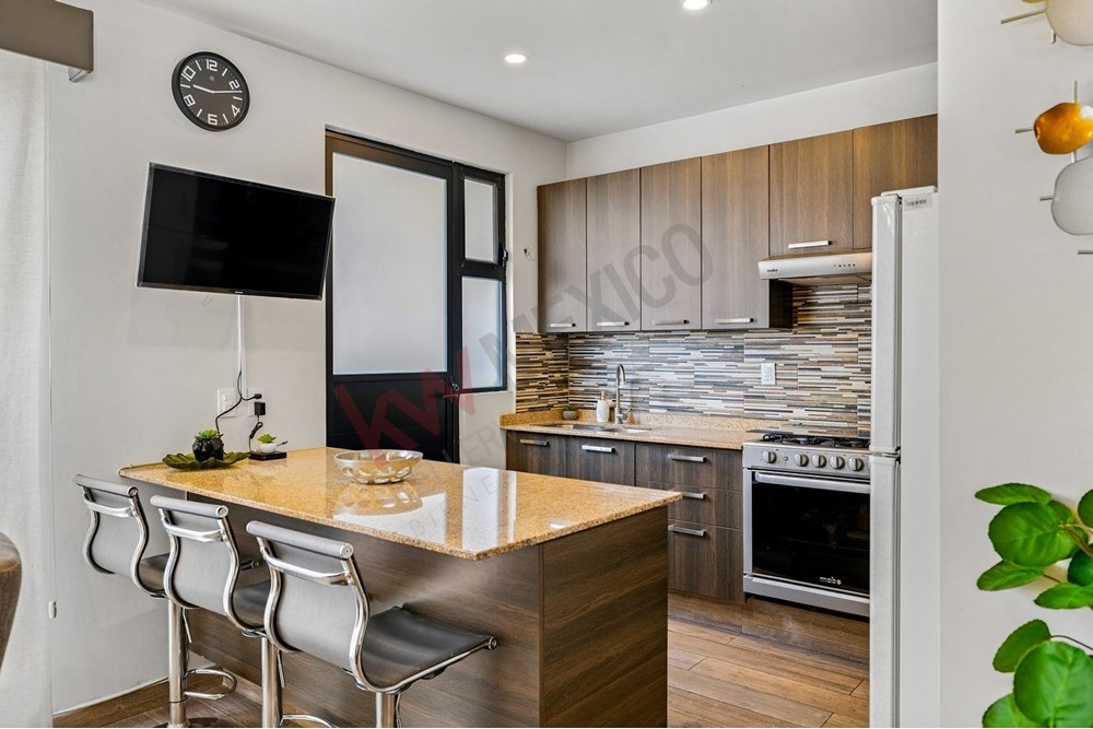 6 of 27: Modern Kitchen, Granite Bar, Wood Grain Cabinets.