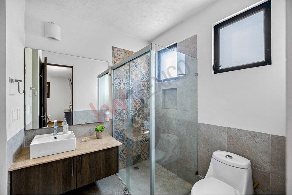 11 of 27: Modern Bathroom, Patterned Shower Tile, Glass Enclosure.