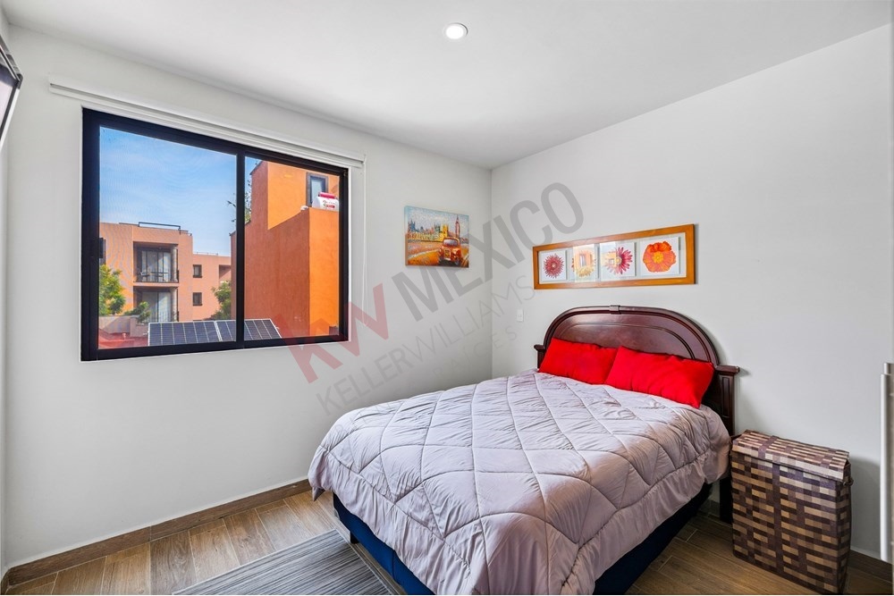 12 of 27: Bright Secondary Bedroom with Window and City Views.
