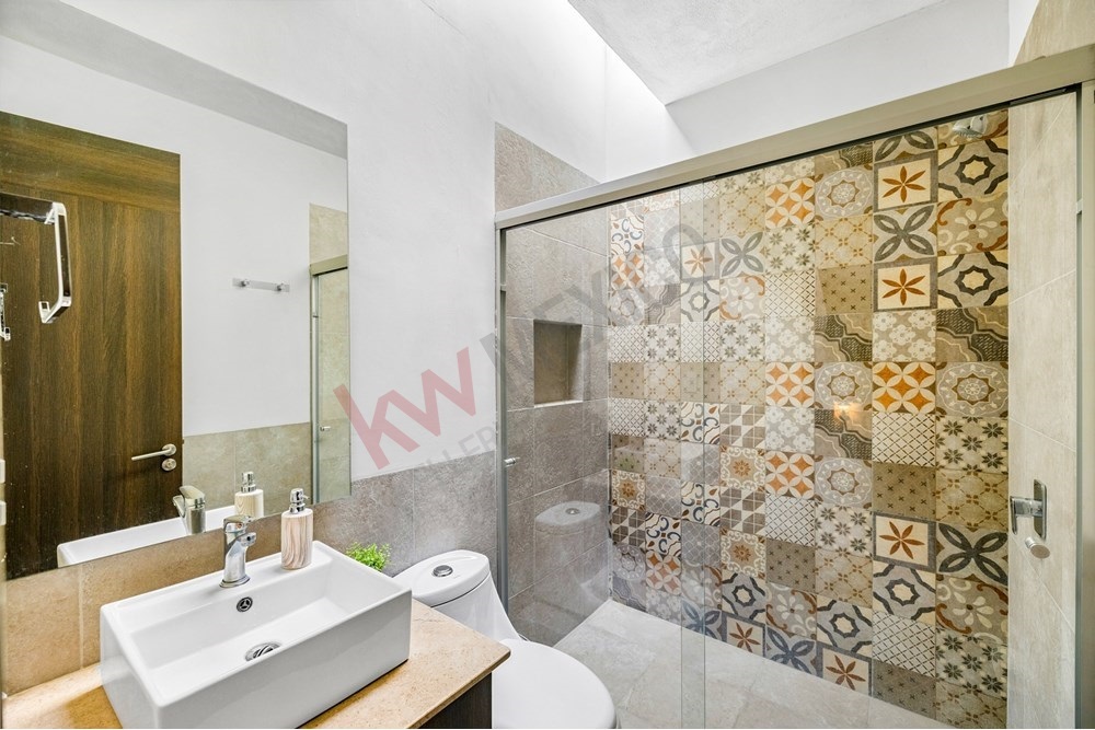 14 of 27: Designer Patterned Shower Tile, Modern Vanity, Glass