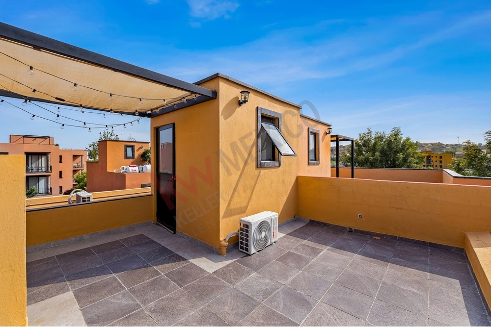 19 of 27: Rooftop Terrace with Covered Pergola and Bright Views.