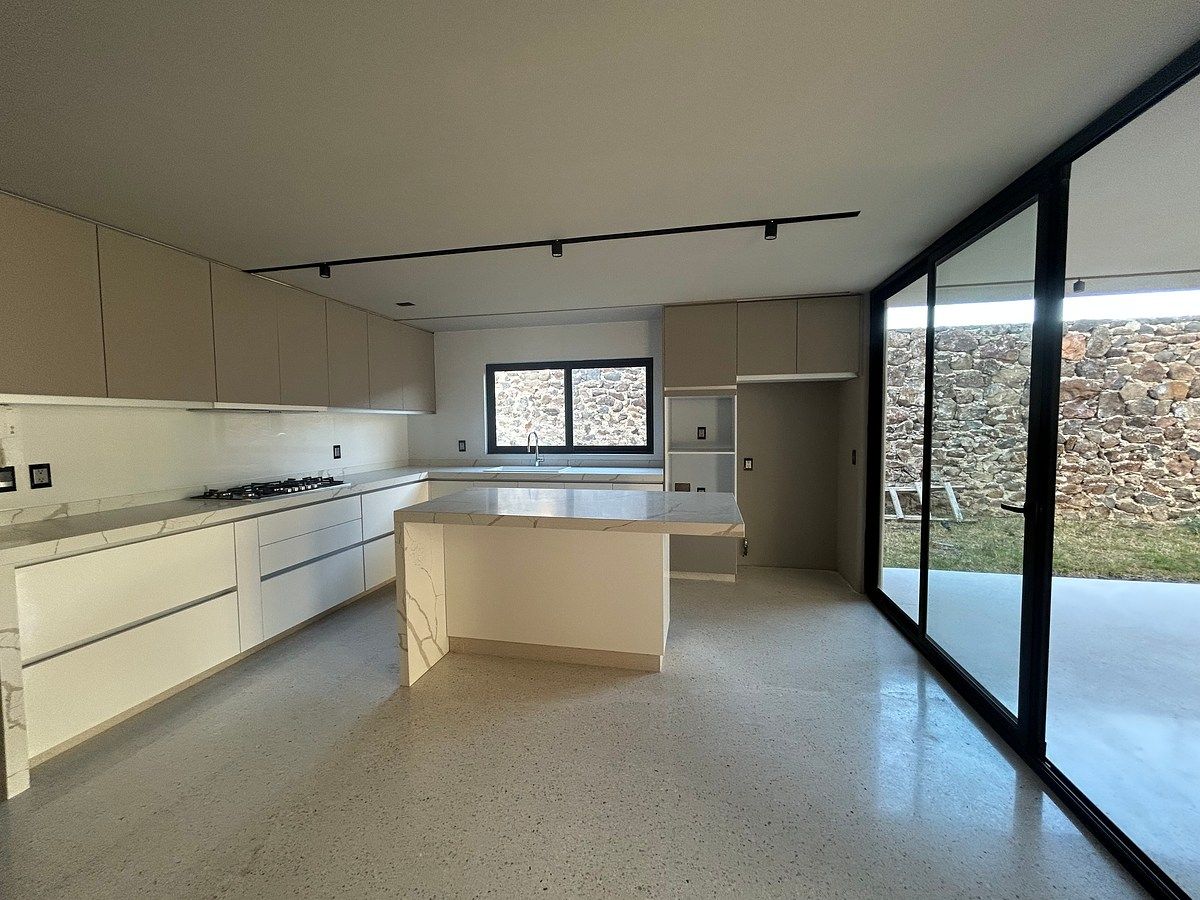 4 of 15: Amplia cocina con mucha luz y ventanales corredizos para int