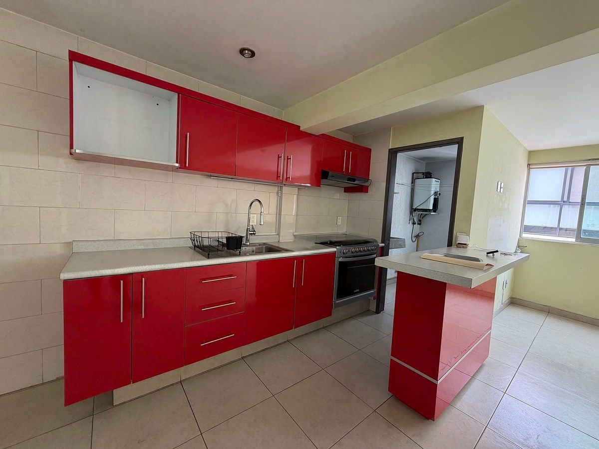 3 of 16: Cocina con estufa, lavabo y barra desayunadora