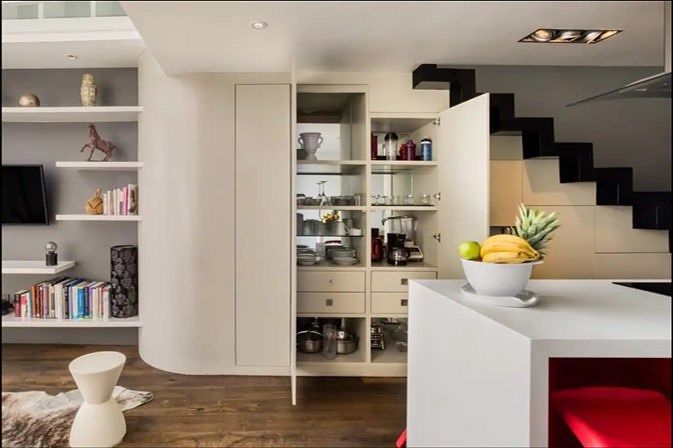 6 de 43: Alacenas ocultas bajo escalera y librero