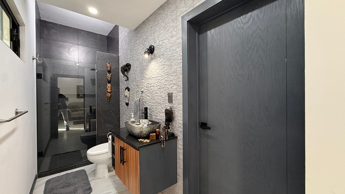 7 of 25: Bano completo en planta baja que se conecta con recamara